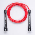 A red jump rope with black handles, coiled in a circle on a white background. The handles are printed with the brand name 'ELITE JUMPS' and 'CORE' in white text.